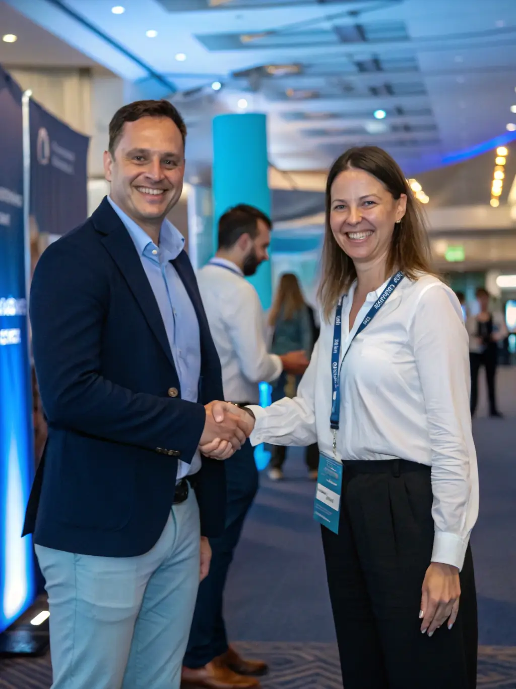 Attendees at InnovateBusiSum celebrating a successful deal closure, shaking hands with smiles, symbolizing the tangible business outcomes from the conference.